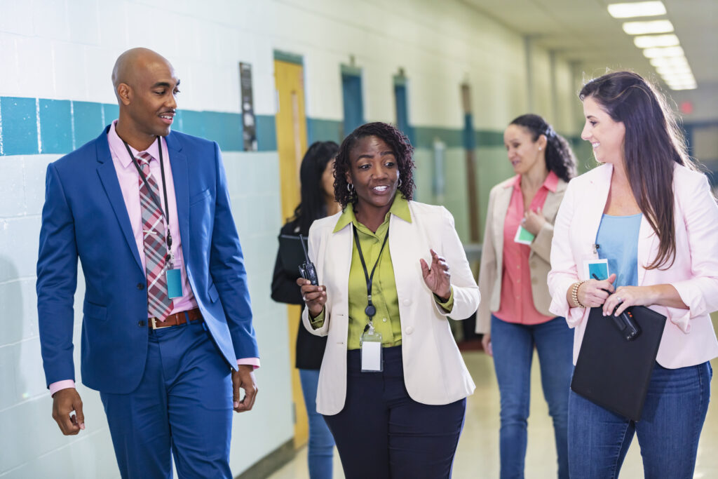 Group of teachers walking in school hallway