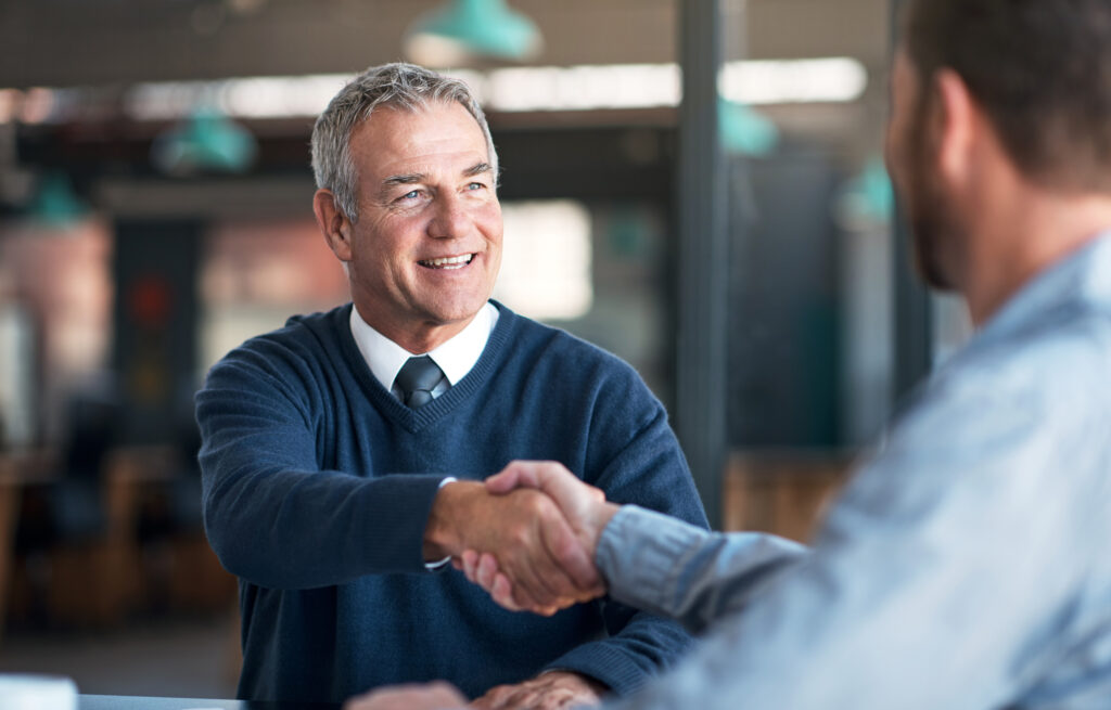 Two businessmen shaking hands in an office